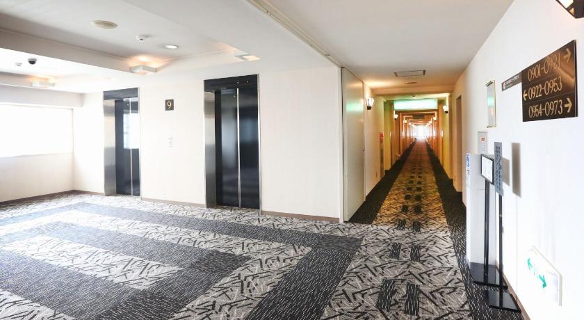 a large room with a rug and a door, APA Hotel & Resort Sapporo in Sapporo
