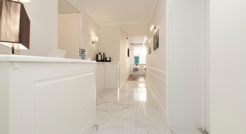 a kitchen with white walls and a white floor, La Fontanina Suites in Naples