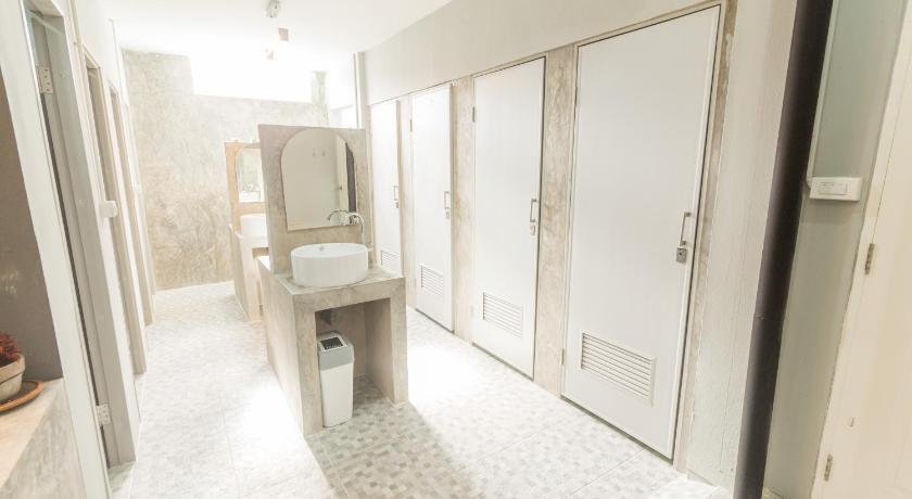 a bathroom with a shower, sink, and toilet, Iris Hostel in Chiang Mai