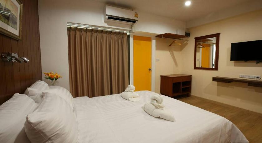 a hotel room with a bed and a television, Baanthanam-nont in Nonthaburi