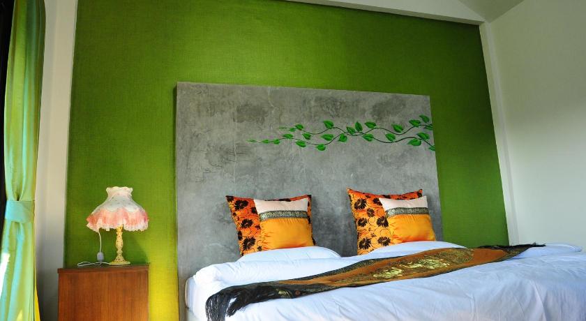 a bedroom with a bed and a painting on the wall, Phumimalee Nature View Resort in Khao Yai