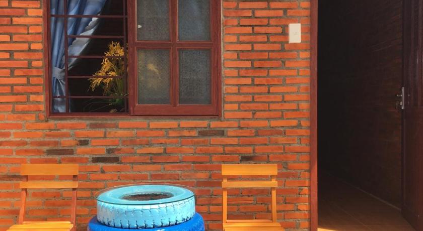 a wooden bench in front of a brick building, Nam Cat Tien Homestay in Nam Cat Tien