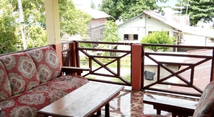 a living room filled with furniture next to a fire hydrant, Novita Homestay in Manado