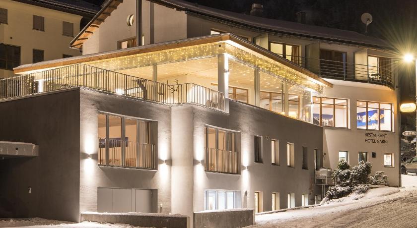 a large building with a lot of windows on top of it, Laagers Hotel Garni in Samedan