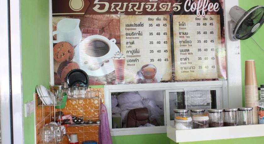 a kitchen with a picture of a cat on the wall, Thanyachatra Boutique. in Phetchaburi