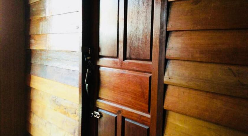 a wooden door leading to a room with a wooden floor, Huen Sabaidee Soi 8 in Chiangkhan