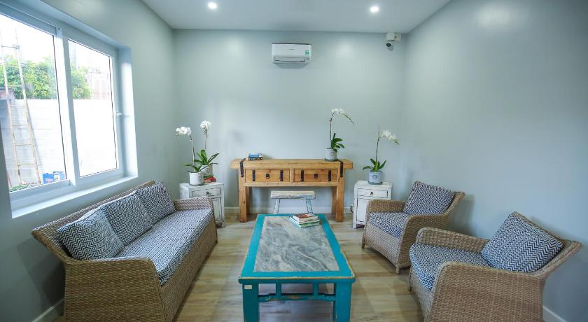 a living room filled with furniture and a table, Serenity by the Sea in Phan Thiet