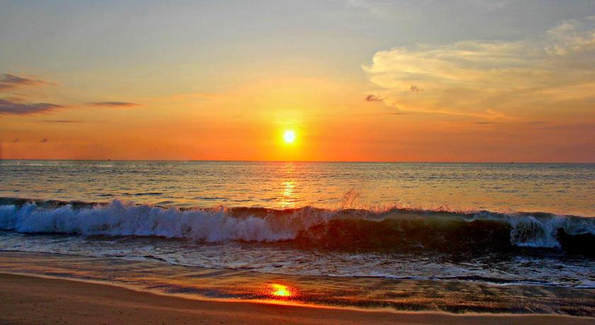 the sun is setting on the beach at sunset, Melasti Beach Resort & Spa in Bali