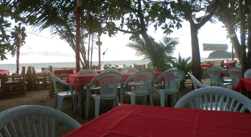 a beach area with tables, chairs and umbrellas, Hans Strand Bungalows in Koh Lanta