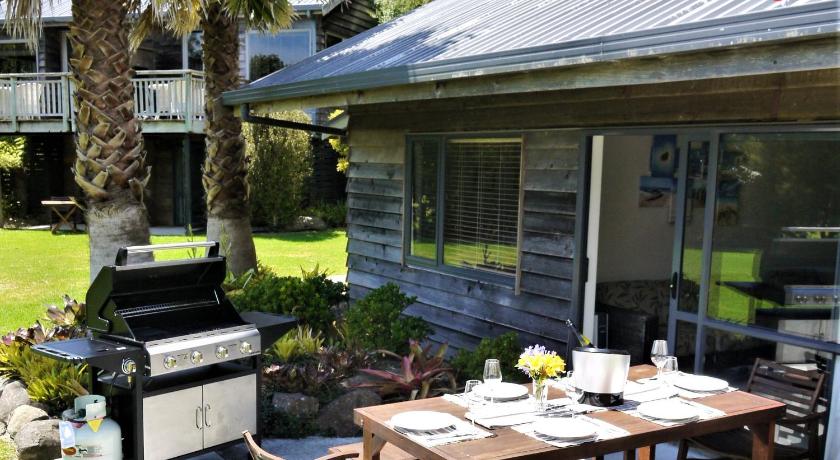 a kitchen with a table and chairs and a fire hydrant, Bay of Islands Holiday Apartments and Campervan Park in Bay of Islands