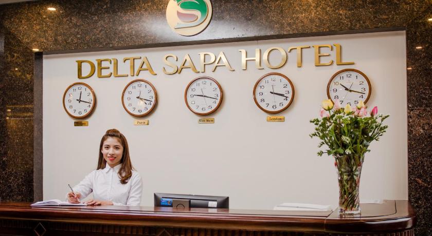 a woman is standing in front of a large clock, Delta Sapa Hotel in Sapa