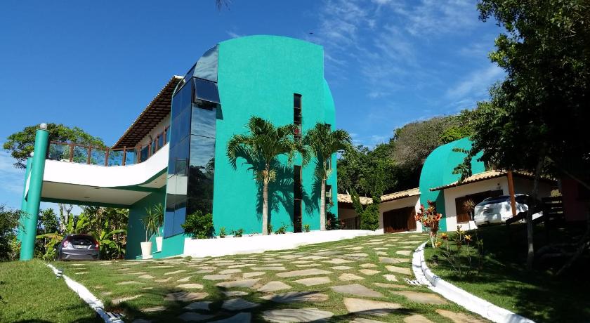 a large green building with a large clock on the front of it, Brava Guest House Buzios in Buzios