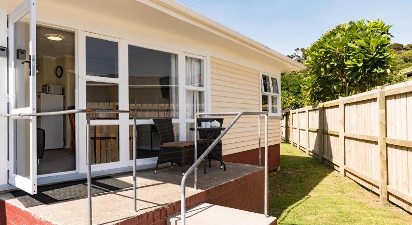 a house with a porch and a window, Waitangi Beach Unit B in Bay of Islands