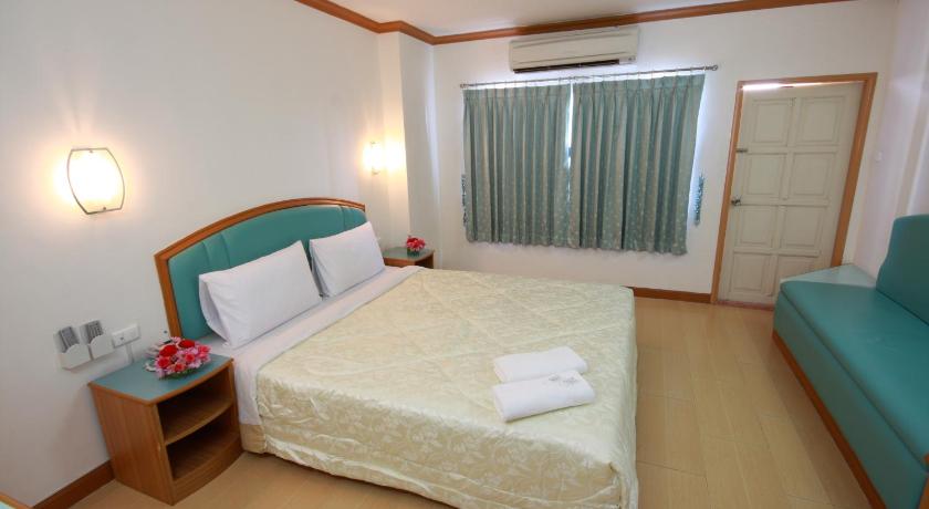a hotel room with a bed and a dresser, P.A. Place Hotel in Nakhon Sawan