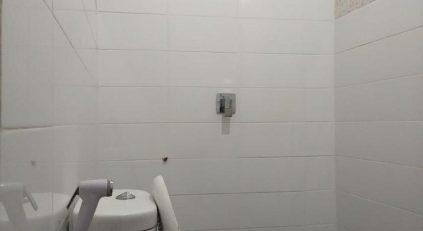 a white toilet sitting in a bathroom next to a sink, Tirta Yoga Inn in Bali