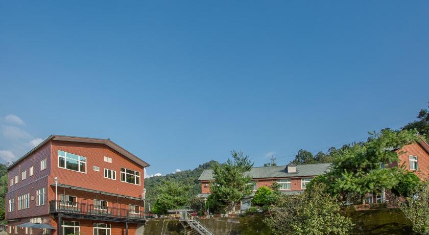 a large brick building with a red roof, Bai Shengcun Homestay in Nantou