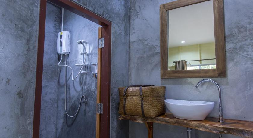 a bathroom with a sink and a mirror, P's Cottage in Trang