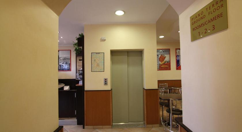 a kitchen area with a refrigerator, sink, and a door, Hotel Della Volta in Brescia