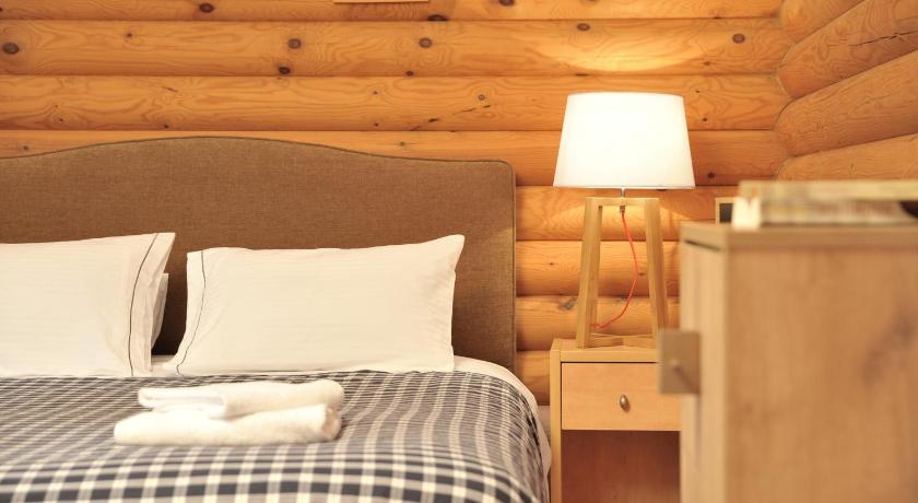 a bedroom with a bed and a lamp, Xenios Chalet in Ano Khora