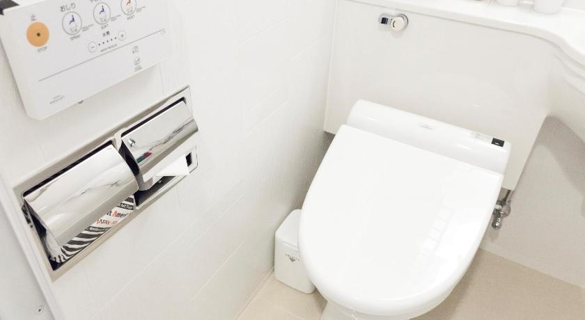 a white toilet sitting next to a white sink, APA Hotel Nagoya Sakae-Higashi in Nagoya