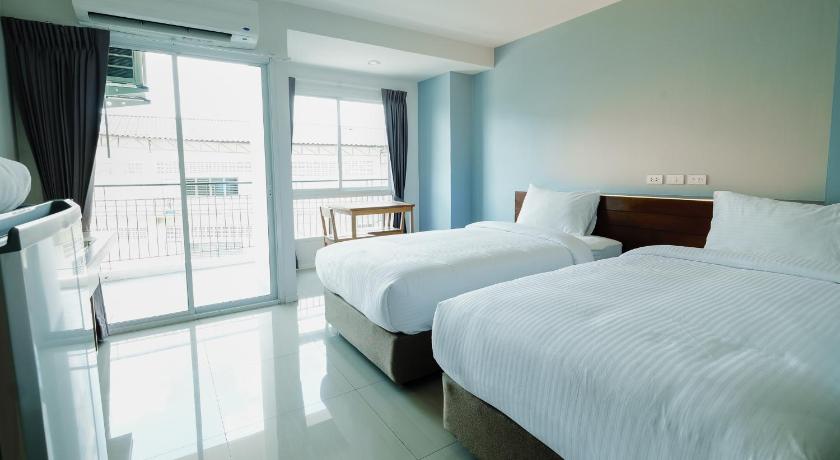 a hotel room with two beds and a window, Thongchen Residence in Samut Sakhon