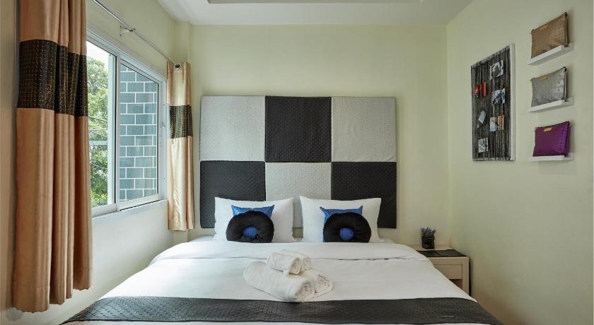 a bedroom with a large bed and a large window, BANGKOK RIVER LOKA in Bangkok