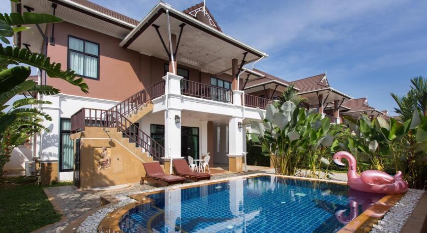 a swimming pool with a pool table and chairs, The Unique Krabi Private Pool Villa in Krabi