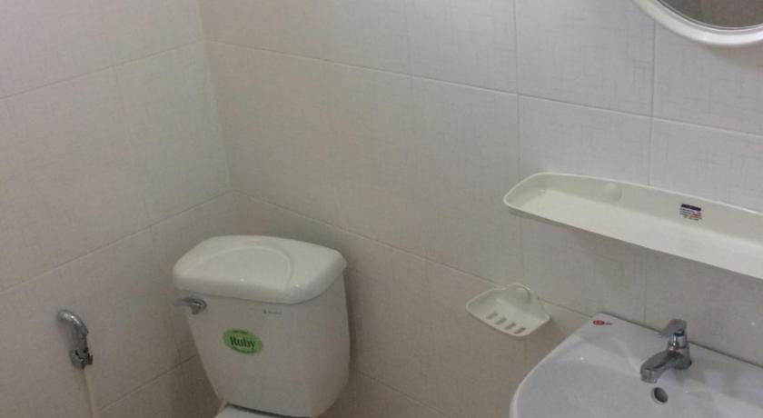a white toilet sitting next to a sink in a bathroom, Y Bon in Phan Thiet