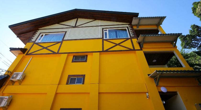 a yellow building with a yellow roof, Taomilu B&B in Nantou