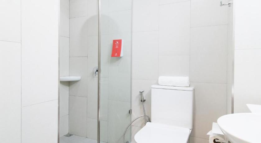 a white toilet sitting in a bathroom next to a shower, Red Planet Manila Bay in Manila
