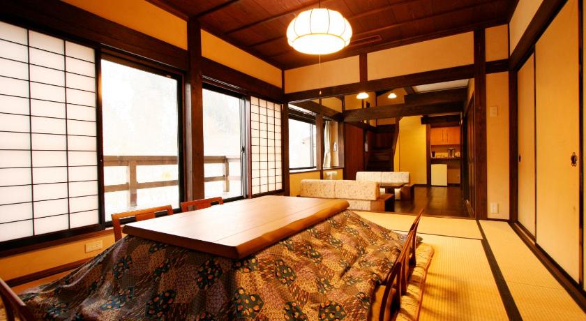 a room with a bed, table, chairs and a window, Yamazatonoiori Soene in Takayama