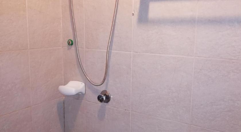 a bathroom with a toilet and a shower stall, 722 Metropolis Tower Unit 212 in Bacolod (Negros Occidental)