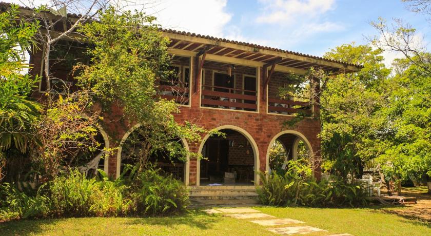 a large brick building with a tree in front of it, Porto de Galinhas Hostel in Porto De Galinhas