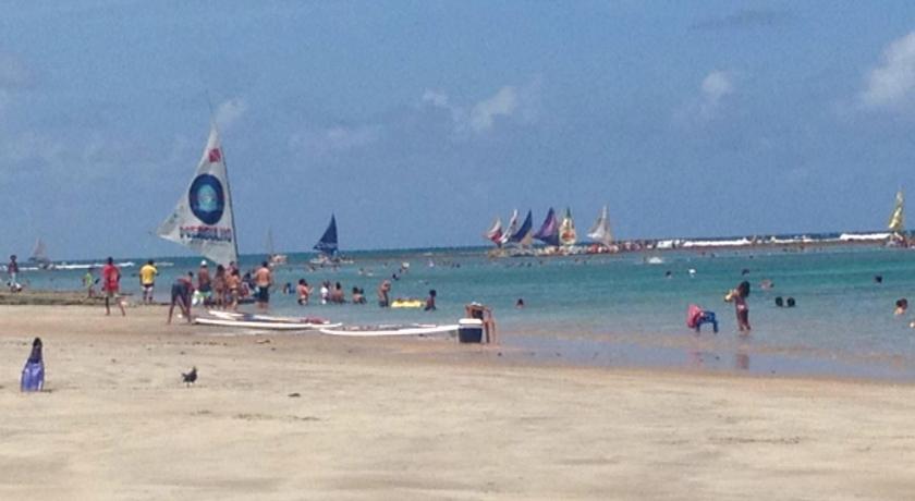 a beach with people and boats on it, Porto de Galinhas Hostel in Porto De Galinhas