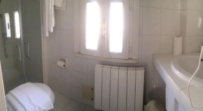 a bathroom with a toilet, sink, and shower, Villaggio In Case Sparse Nel Centro Storico in Martina Franca