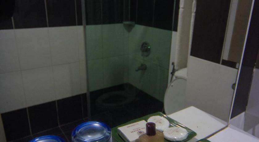 a bathroom with a sink and a counter top, Penview Hotel in Kuching
