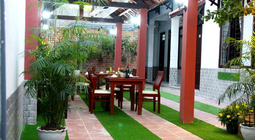 a patio area with a table, chairs, and tables, Phuc An Homestay in Hoi An