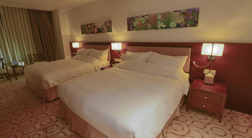 a hotel room with a bed and two lamps, Aristo International Hotel in Lao Cai City