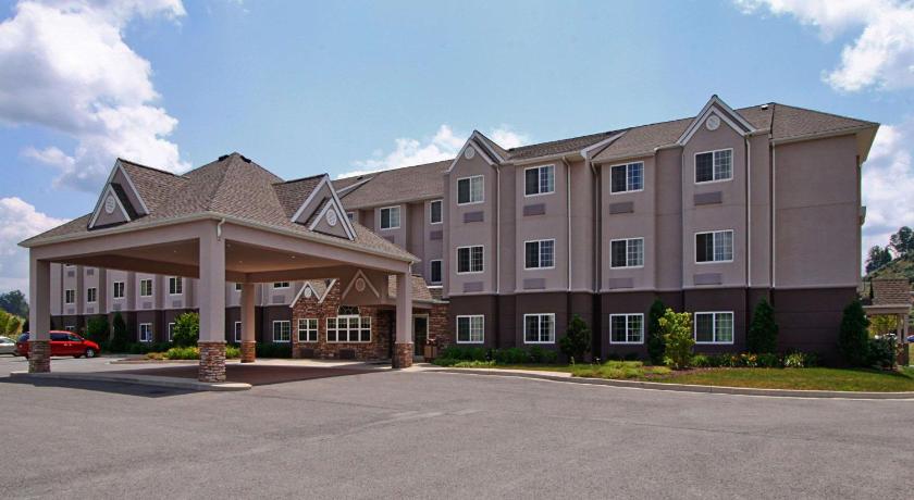 a large brick building with a large window, Microtel Inn & Suites by Wyndham Bridgeport in Bridgeport (WV)