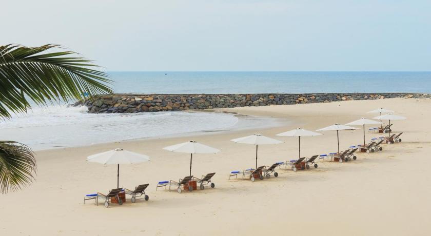 a beach filled with lots of umbrellas on a sunny day, The Cliff Resort and Residences in Phan Thiet