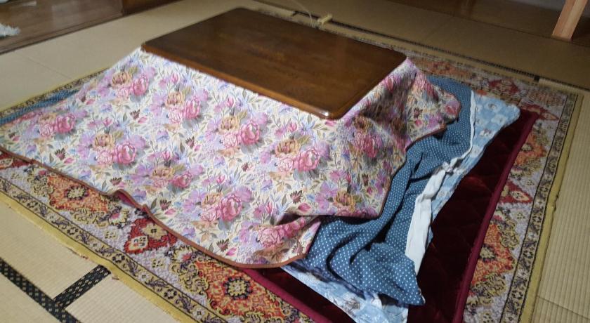 a blanket is laying on a rug on the floor, Private House Minshuku Tateishi A in Shimonoseki