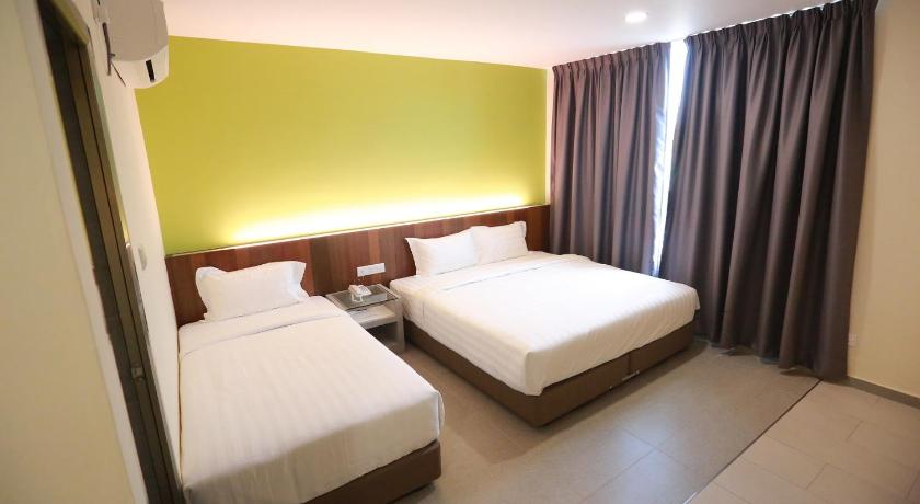 a hotel room with two beds and two lamps, Pantai Regal Boutique Hotel in Kuantan
