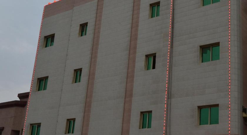 a building with a sign on the side of it, Ahla Amassi Furnished Units in Dammam