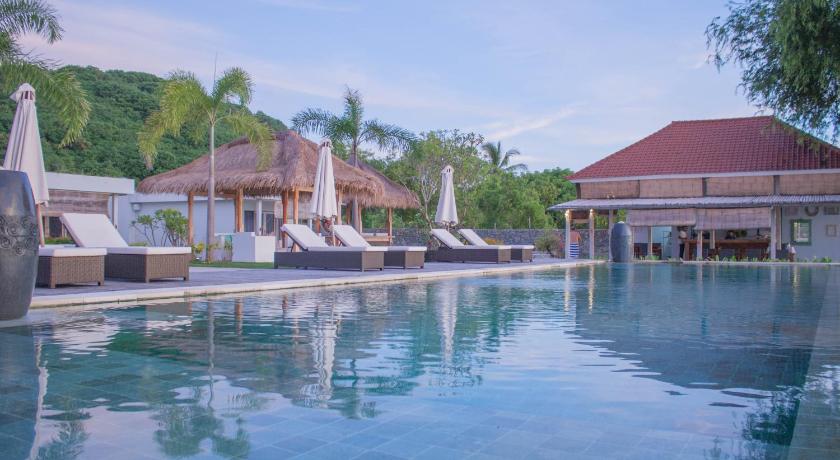a large swimming pool in front of a large building, The Suites Lombok in Lombok