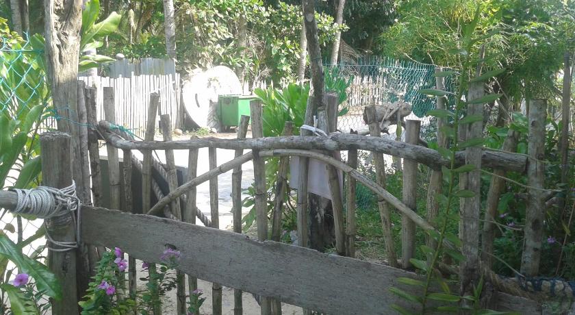 a wooden bench in front of a fence, Pandan Beach Homestay in Lundu