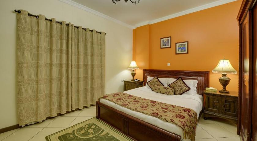 a bedroom with a large bed and a large window, Ramee Suite 4 Hotel in Manama