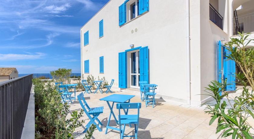 a blue and white patio with chairs and tables, Room & Breakfast Cala Azzurra in San Vito Lo Capo