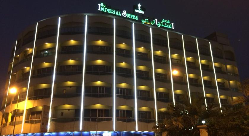 a large building with a large clock on top of it, Imperial Suites Hotel in Manama