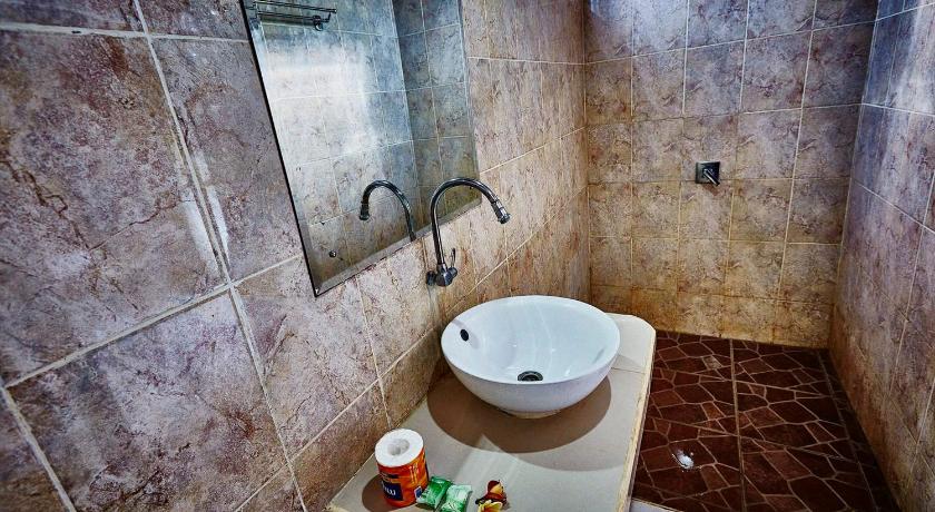 a bathroom with a sink, toilet and bathtub, Matra Bali Guest House in Bali