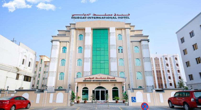 a large building with a clock on the front of it, Muscat International Hotel in Muscat
